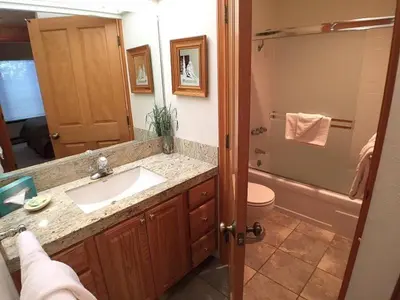 a bathroom with a sink and a toilet and a mirror at Standard Condos with Free Parking in Mammoth Lakes