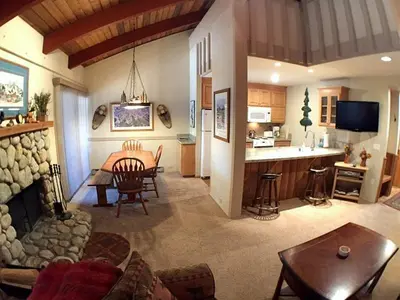 a living room with a kitchen and a living room with a fireplace at 2 Bedrooms Premium Condos in Mammoth Lakes