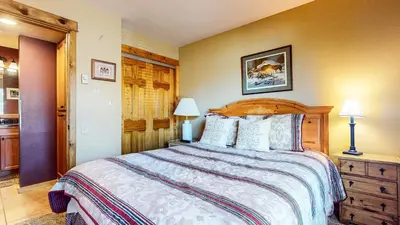 a bedroom with a large bed with a wooden headboard at Discover 4 in Mammoth Lakes