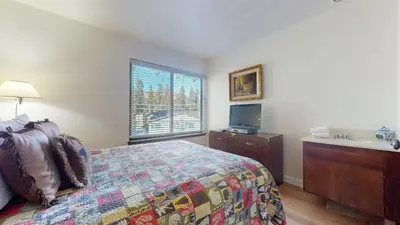 a bedroom with a bed and a sink and a window at Discover 4 in Mammoth Lakes