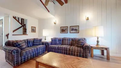 a living room with two couches and a table at Discover 4 in Mammoth Lakes