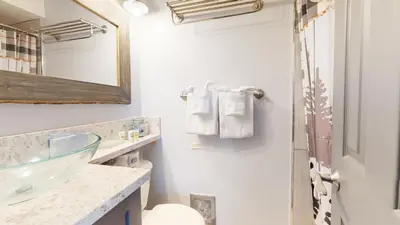 a bathroom with a sink and a mirror at Mammoth Estates Condo - Free Parking & Pet Friendly in Mammoth Lakes