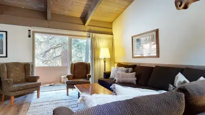 a living room with a couch and two chairs at Mammoth Estates Condo - Near Village at Mammoth & Pet Friendly in Mammoth Lakes