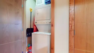 a white refrigerator in a room with a door at Solstice 11 Amazing Location on Golf Course, Heated Garage, Private Washer Dryer condo in Mammoth Lakes
