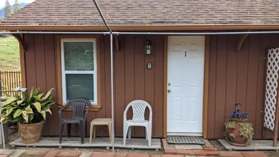 two chairs and a table on the porch of a house at Apple Place Room #1 in Miramonte