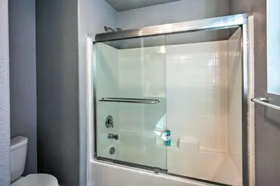 a shower with a glass door in a bathroom at Modern Sacramento House about 12 Mi to Downtown! in Sacramento