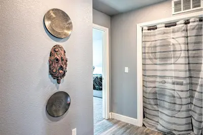 a room with a wall with plates on the wall at Modern Sacramento House about 12 Mi to Downtown! in Sacramento