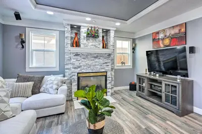 a living room with a fireplace and a television at Modern Sacramento House about 12 Mi to Downtown! in Sacramento