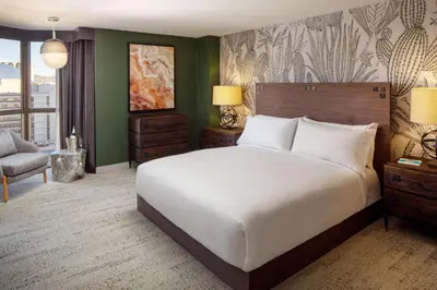 a bedroom with a large white bed and green walls at Whitney Peak Hotel Reno, Tapestry Collection by Hilton in Reno