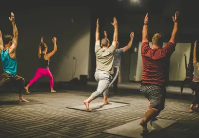 a group of people doing yoga on a stage at Whitney Peak Hotel Reno, Tapestry Collection by Hilton in Reno