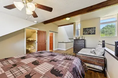 a bedroom with a bed and a ceiling fan at Luxury Auberry Retreat in Sierra National Forest in Auberry