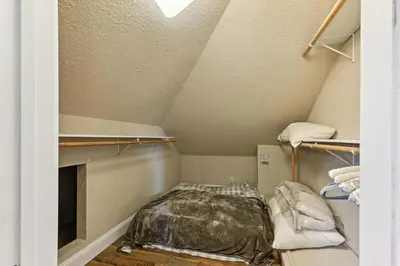 a small room with a bed in a attic at Luxury Auberry Retreat in Sierra National Forest in Auberry