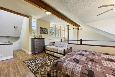 a bedroom with a bed and a dresser at Luxury Auberry Retreat in Sierra National Forest in Auberry