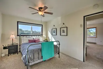 a bedroom with a bed with a ceiling fan at Jackson Escape with Hot Tub and Mtn Views! in Jackson