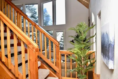 a wooden staircase with a plant in a house at Sweet getaway in private Giant Sequoia Grove! in Springville