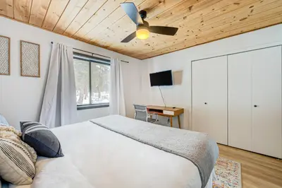 a bedroom with a bed and a ceiling fan at Bolzano's Getaway in Truckee