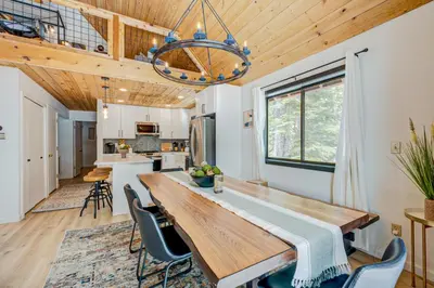 a kitchen and dining room with a wooden table and chairs at Bolzano's Getaway in Truckee