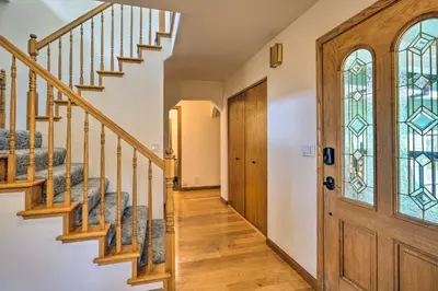 a hallway with stairs and a wooden door at 10 Acres with Stunning Views Apple Hill Home! in Camino