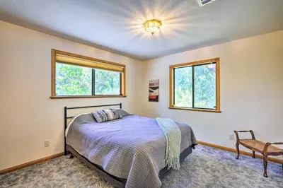 a bedroom with a bed and two windows at 10 Acres with Stunning Views Apple Hill Home! in Camino