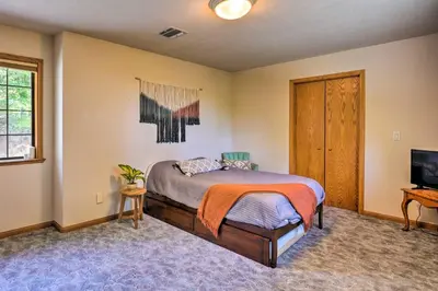 a bedroom with a bed and a flat screen tv at 10 Acres with Stunning Views Apple Hill Home! in Camino