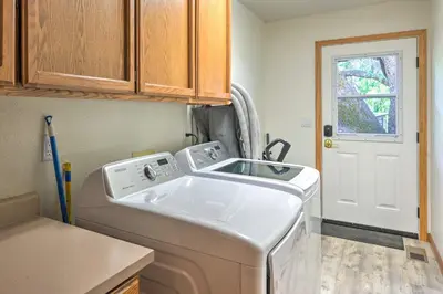 a kitchen with a washing machine and a sink at 10 Acres with Stunning Views Apple Hill Home! in Camino