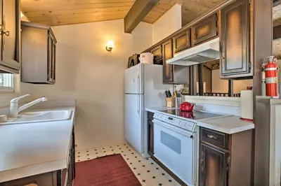 a kitchen with a white refrigerator and a sink at Mammoth Lakes Townhome Less Than 2 Mi to Ski Area! in Mammoth Lakes