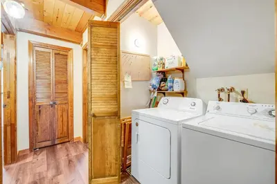 a laundry room with a washer and dryer at Tranquility in the Woods in Arnold