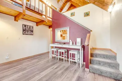 a room with a table and stools in a house at Tranquility in the Woods in Arnold