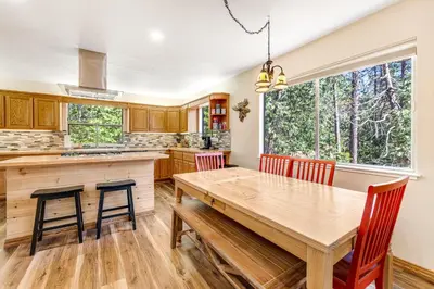 a kitchen with a wooden table and chairs at Paws Place in Arnold