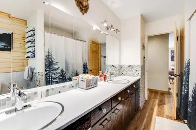 a bathroom with two sinks and a large mirror at Paws Place in Arnold