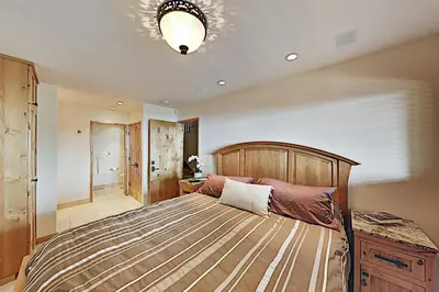 a bedroom with a large bed with a wooden headboard at Bitterbrush 25 in Incline Village