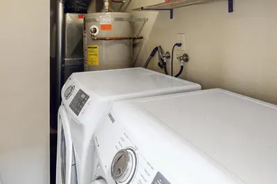 a washing machine in a room with a refrigerator at Lakeshore Townhome 20 in Incline Village