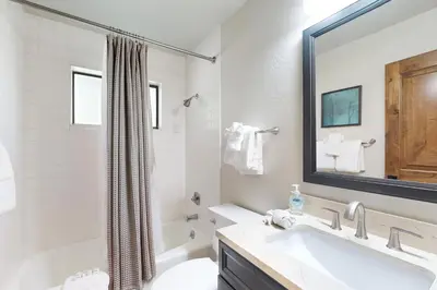 a bathroom with a sink and a toilet and a mirror at Lakeshore Townhome 20 in Incline Village