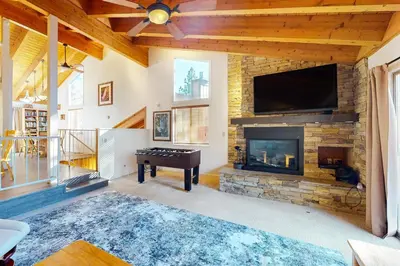 a living room with a fireplace and a flat screen tv at Lake Village Townhouse B in Zephyr Cove