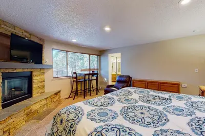a bedroom with a bed and a fireplace at Lake Village Townhouse B in Zephyr Cove