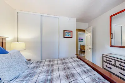 a bedroom with a bed and a mirror at Allen Way Escape in Incline Village