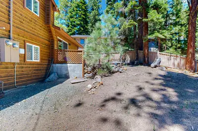 a house with a fence next to a driveway at Allen Way Escape in Incline Village