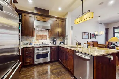 a kitchen with wooden cabinets and stainless steel appliances at Northstar Lodge Luxury in Kingswood Estates