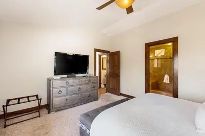 a bedroom with a bed and a flat screen tv at Tyner Dreams in Incline Village