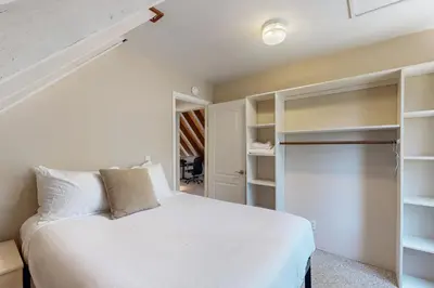 a bedroom with a white bed and a closet at Lake View Escape in Incline Village