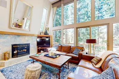 a living room with leather furniture and a fireplace at Boothill Adventures in Incline Village