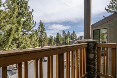 a balcony with a view of the woods at New Listing 2 bedroom and Loft 2 bath Summit E Bldg 12 condo sleeps 8 Steps to Eagle Lodge Chair 15 in Mammoth Lakes