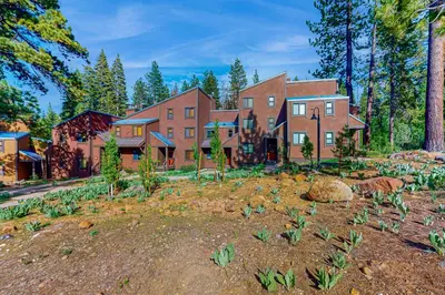 a large house with a garden in front of it at Aspen Grove Condo in Truckee