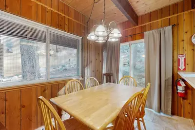 a dining room with a wooden table and chairs at Conifer Donner in Truckee