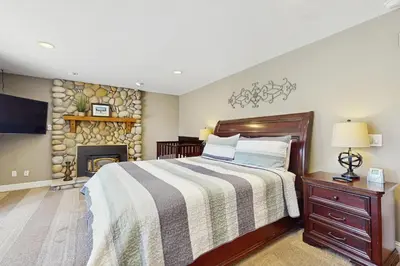 a bedroom with a bed and a fireplace at Skyline Manor in South Lake Tahoe
