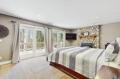 a bedroom with a bed and a large window at Skyline Manor in South Lake Tahoe