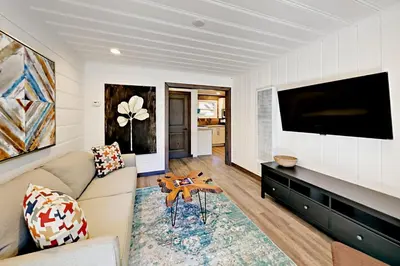 a living room with a couch and a flat screen tv at Manzanita Holiday 4 in South Lake Tahoe