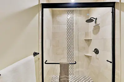 a shower with a glass door in a bathroom at Saponi Escape in South Lake Tahoe