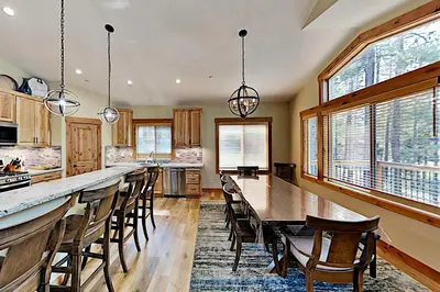 a large kitchen with a long table and chairs at Saponi Escape in South Lake Tahoe