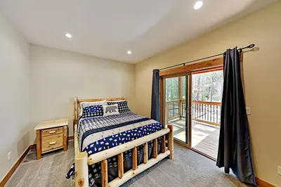 a bedroom with a bed and a balcony at Saponi Escape in South Lake Tahoe